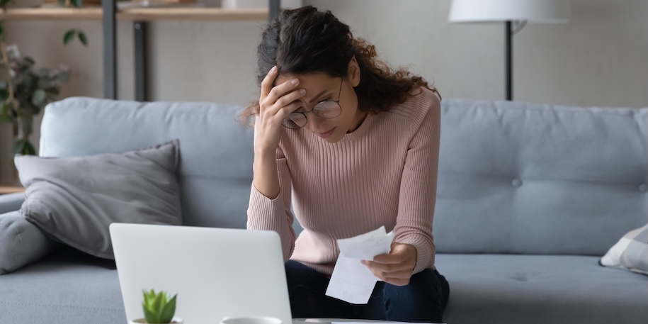 young woman in glasses feeling stressed calculating monthly expenses at home, facing financial problems or lack of money for utility household or rental payments, bankruptcy