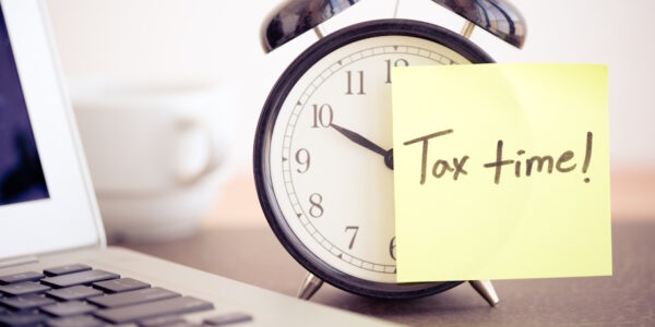 clock with tax time reminder on post it