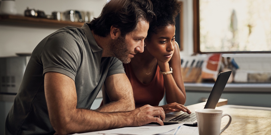 couple looking at bills on computer