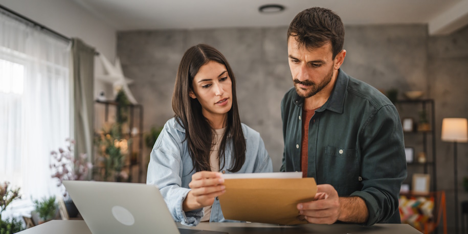 couple looking over loan paperwork couple looking over loan paperwork
