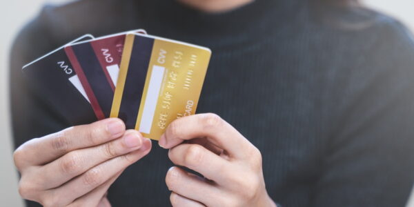 woman looking at many credit cards in her hand