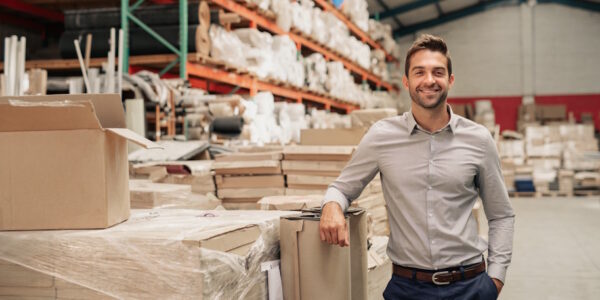 happy business owner in warehouse