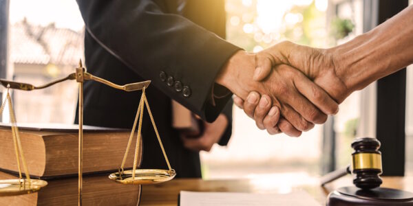 lawyer shaking hands with client