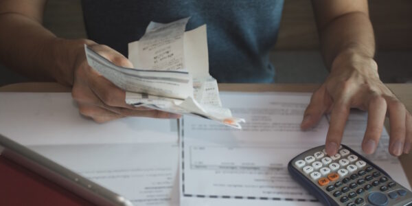 man using calculator for calculate expenses accounts man using calculator for calculate expenses accounts