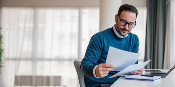 man looking at papers at a desk man looking at papers at a desk
