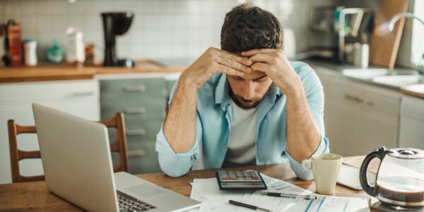 man stressed out by debt