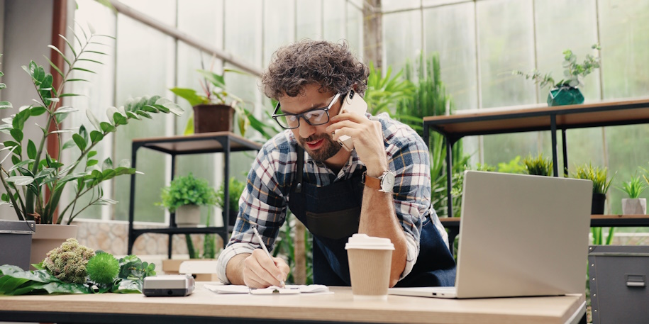 man talking on phone in a plant shop man talking on phone in a plant shop