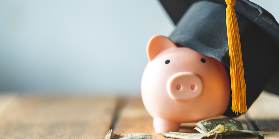 piggy bank with money and graduation cap piggy bank with money and graduation cap