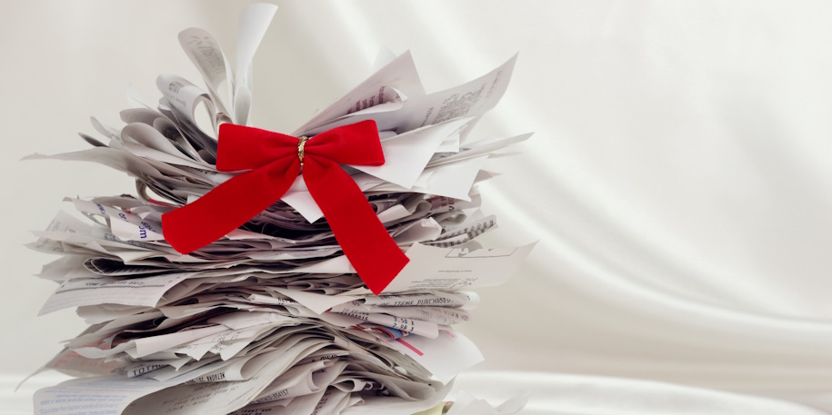 stack of holiday shopping receipts with red bow on top stack of holiday shopping receipts with red bow on top