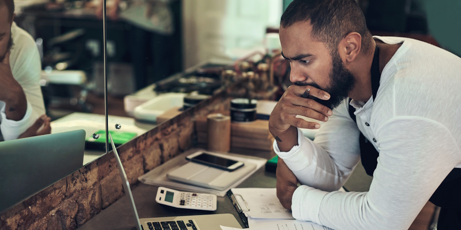stressed business owner looking at finances