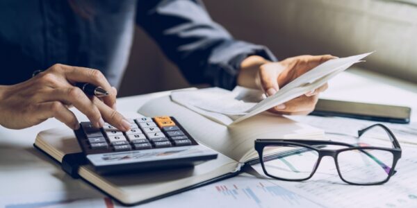 a man works with documents and a calculator on a desk