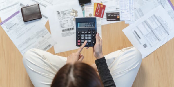 woman calculates debt with a calculator