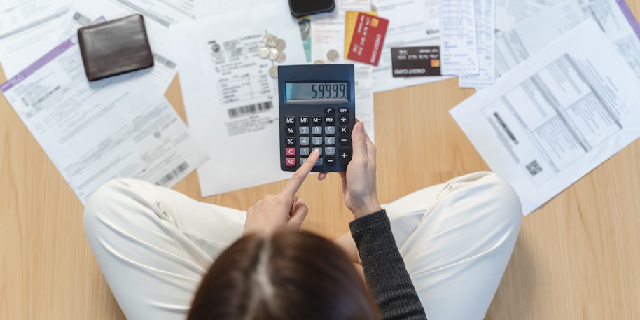woman calculates debt with a calculator woman calculates debt with a calculator