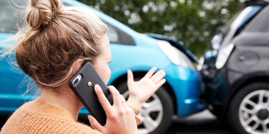 woman on the phone by a car accident woman on the phone by a car accident