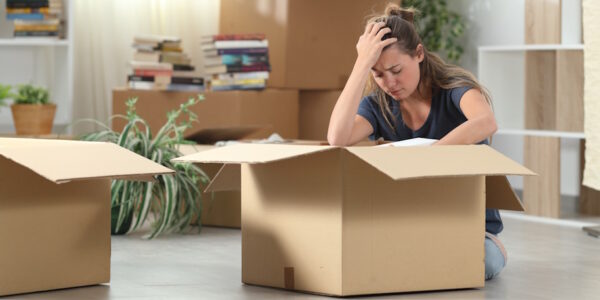 woman sadly packs up her home